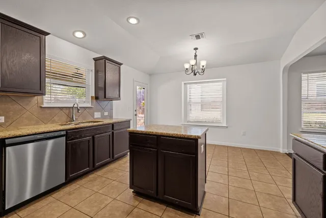 a kitchen with a sink and a stove top oven