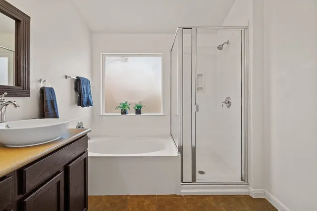 a bathroom with a tub sink and mirror