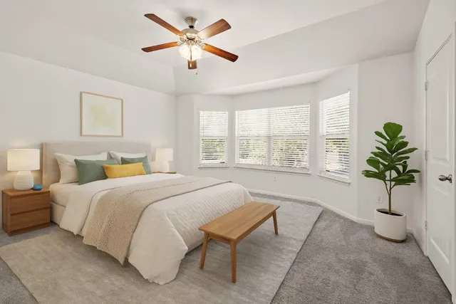 a bedroom with a bed and a potted plant