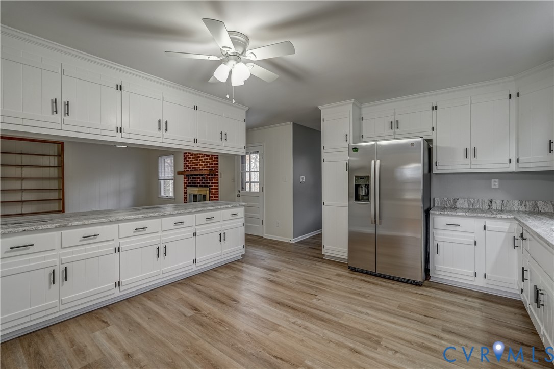3534 Davis Mill Road Goochland, VA 23063 - Photo 18 of 40 a kitchen with granite countertop white cabinets white stainless steel appliances and wooden floors
