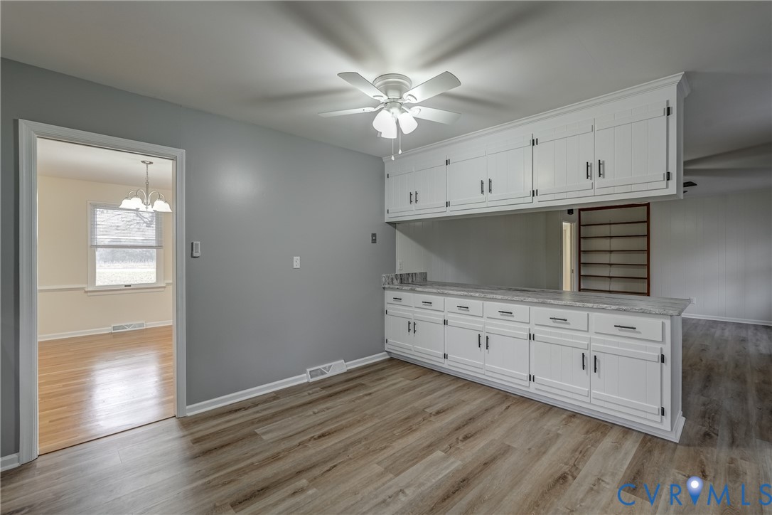 3534 Davis Mill Road Goochland, VA 23063 - Photo 21 of 40 a kitchen with cabinets wooden floor and a ceiling fan