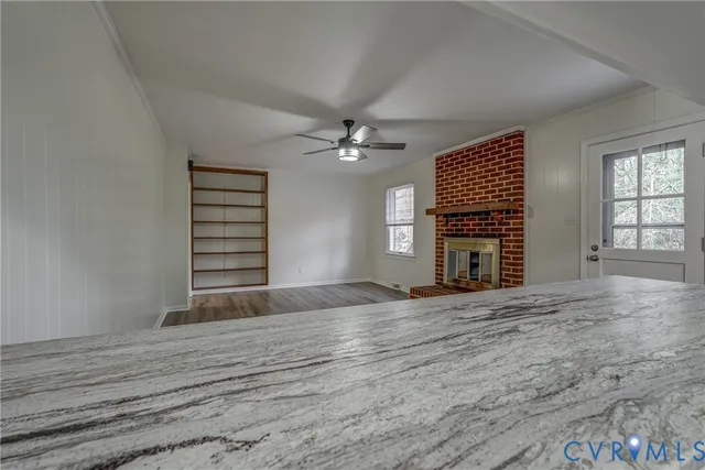 a view of wooden floor chandelier and window in a room