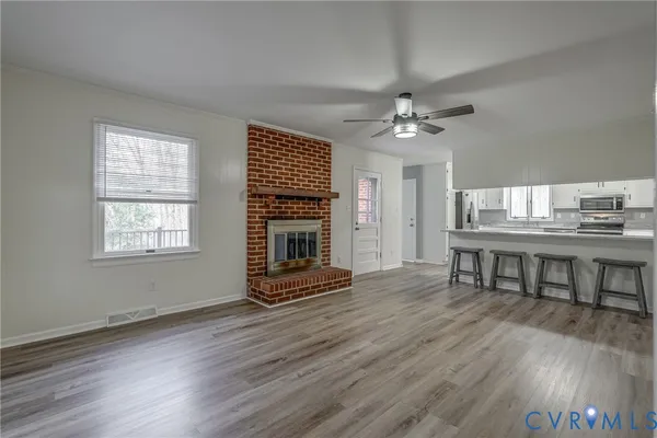 a view of livingroom and dining room with furniture wooden floor