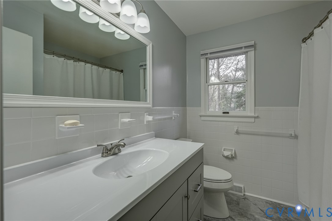 3534 Davis Mill Road Goochland, VA 23063 - Photo 34 of 40 a bathroom with a sink vanity granite toilet and a mirror