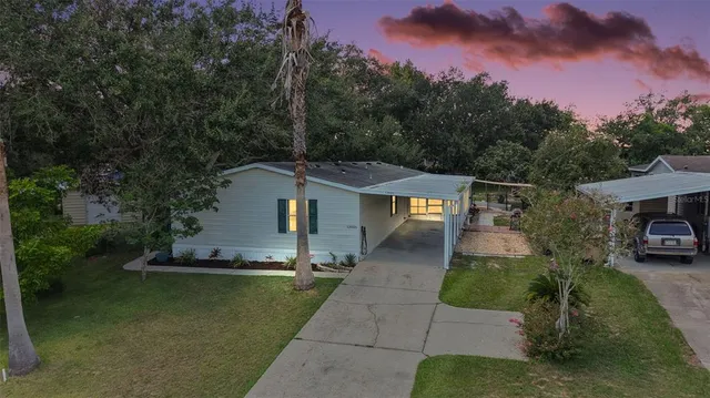 a front view of a house with a garden and yard