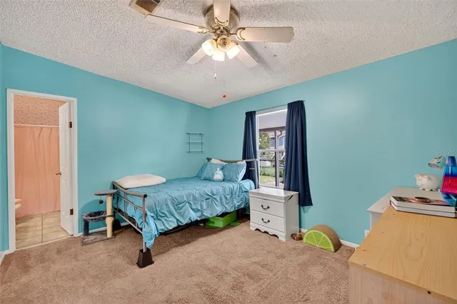 a bedroom with bed and a chandelier
