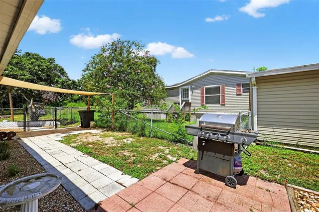 a view of a backyard with sitting area