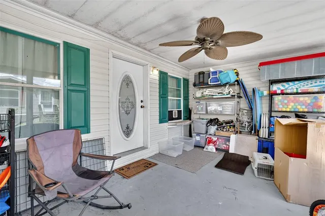 a living room with furniture a flat screen tv and a window