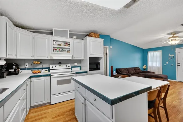 a kitchen with a stove a sink and a refrigerator