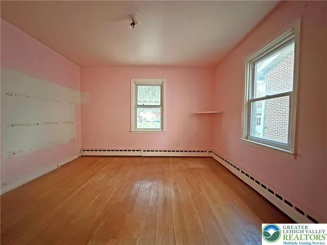 an empty room with a empty space and windows