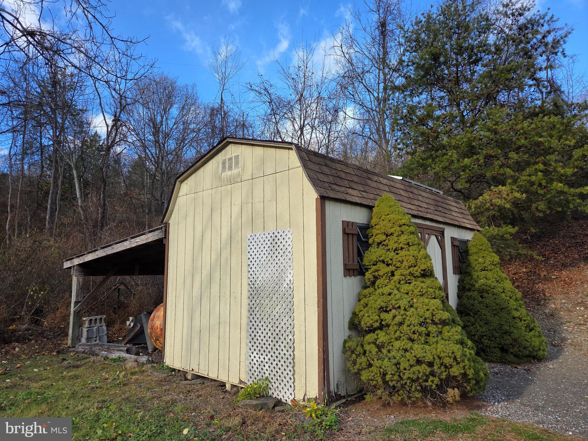 83 Woodpecker Drive Mount Pleasant Mills, PA 17853 - Photo 69 of 87 Charming shed nestled in nature's embrace.