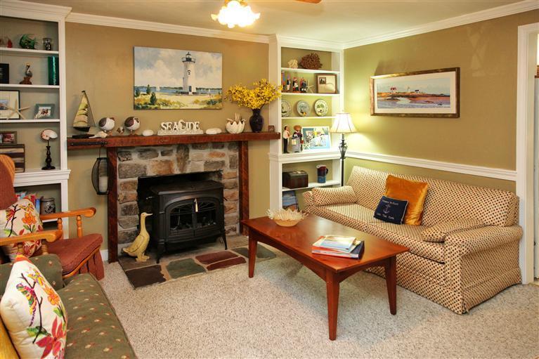 94 Waterfield Road Osterville, MA 02655 - Photo 3 of 12 a living room with furniture and a fireplace