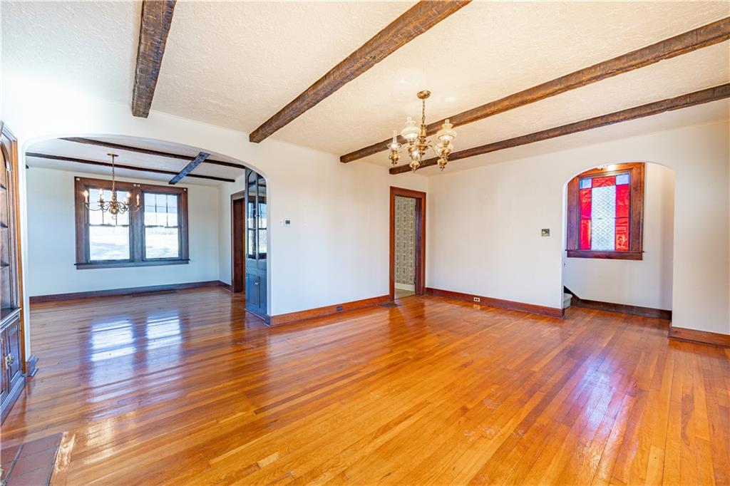 422 New Castle Road Butler, PA 16001 - Photo 4 of 27 a view of an empty room with wooden floor and a window