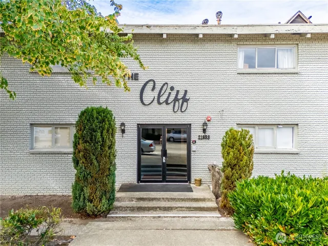 a view of a street with a building and a street sign