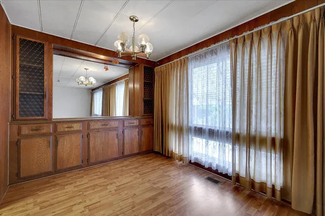 a view of a bathroom with a large window and wooden floor