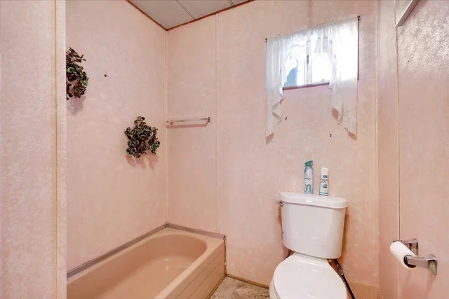 a white toilet sitting next to a bathroom sink