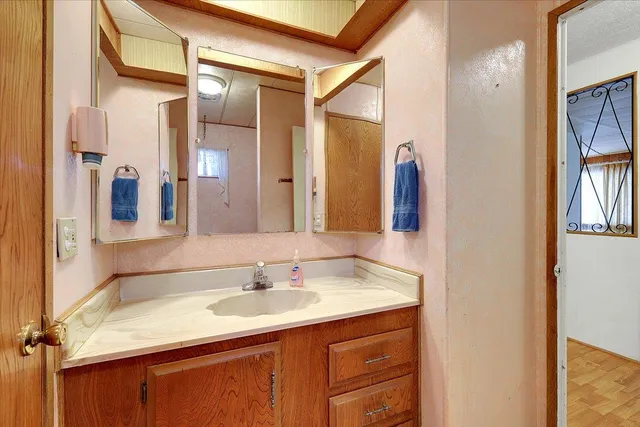 a bathroom with a sink vanity granite and a mirror