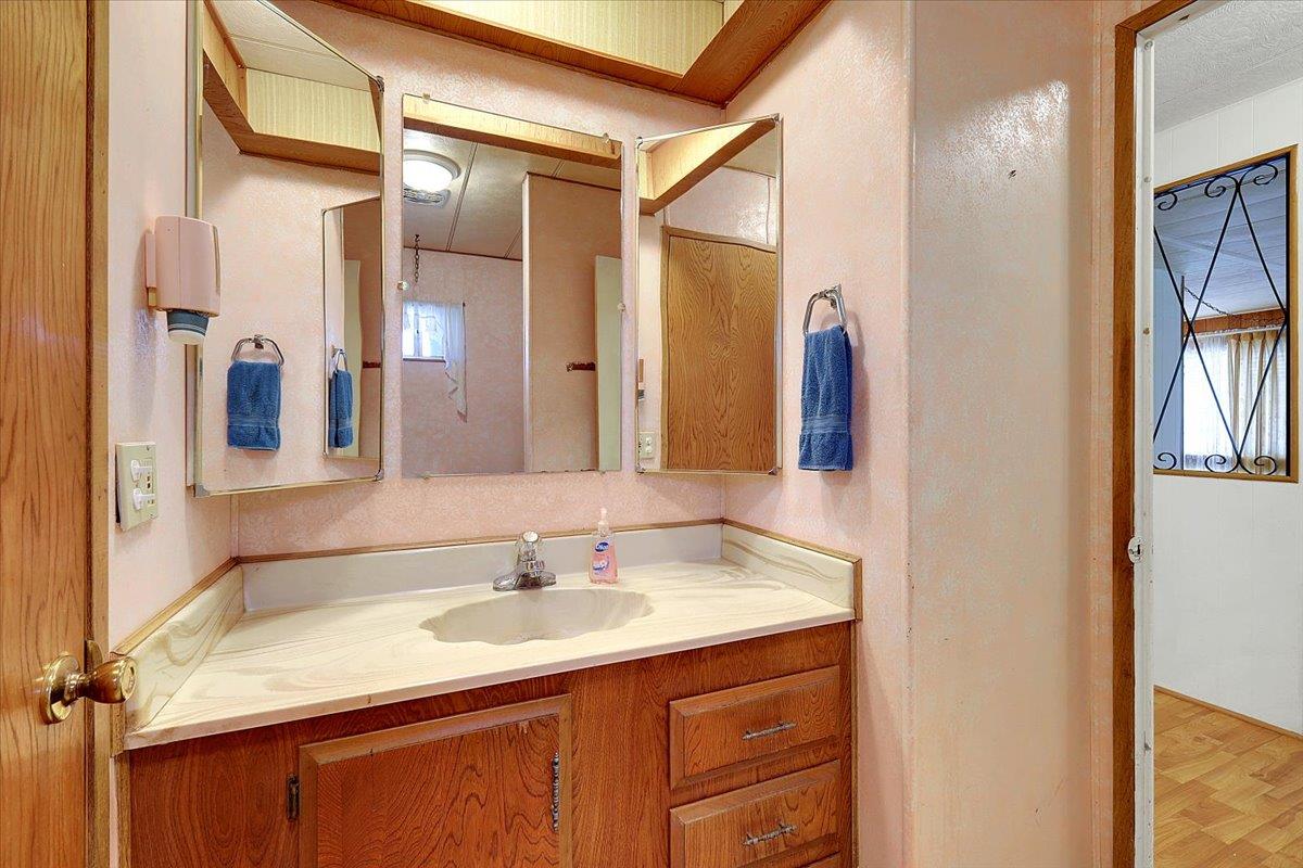 10383 Larkin Road, Unit 43 Live Oak, CA 95953 - Photo 19 of 26 a bathroom with a sink vanity granite and a mirror