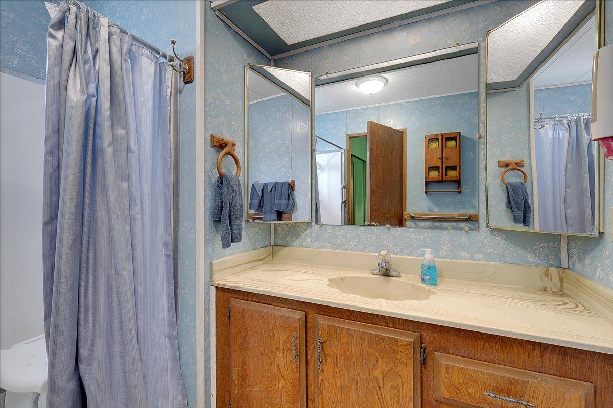 10383 Larkin Road, Unit 43 Live Oak, CA 95953 - Photo 21 of 26 a bathroom with a sink double vanity and a mirror