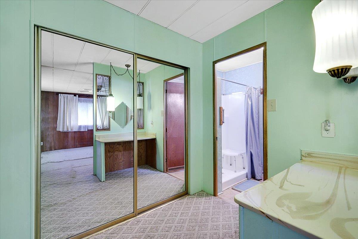 10383 Larkin Road, Unit 43 Live Oak, CA 95953 - Photo 22 of 26 a bedroom with a bed and a mirror