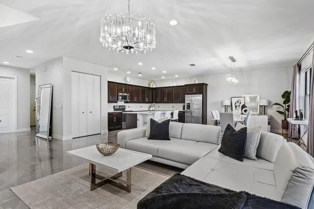 a living room with furniture and a chandelier