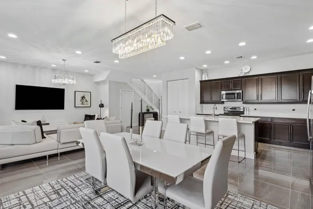 a kitchen with stainless steel appliances kitchen island granite countertop a refrigerator and a stove top oven