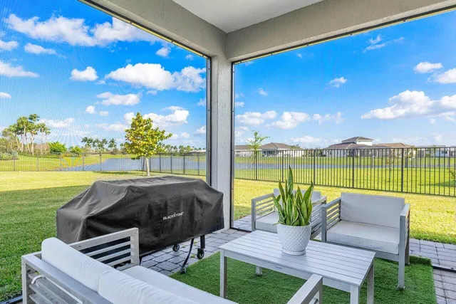 a view of a house with a backyard porch and sitting area