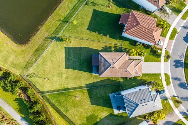 an aerial view of residential houses with outdoor space and swimming pool