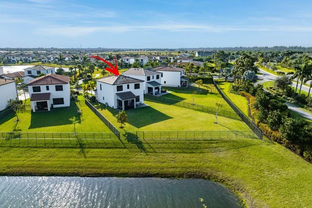 an aerial view of residential houses with outdoor space and swimming pool
