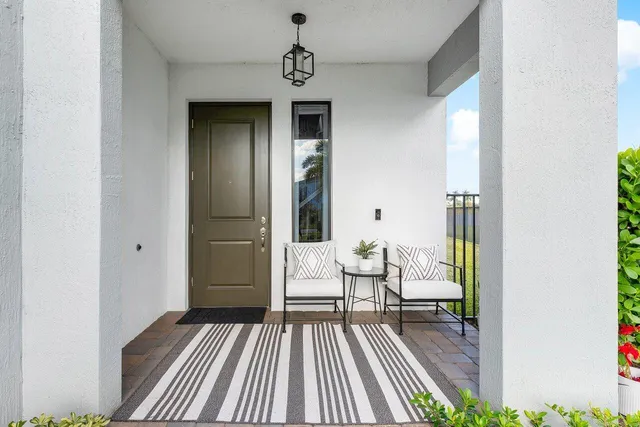 a view of a bedroom with a bed and wooden floor