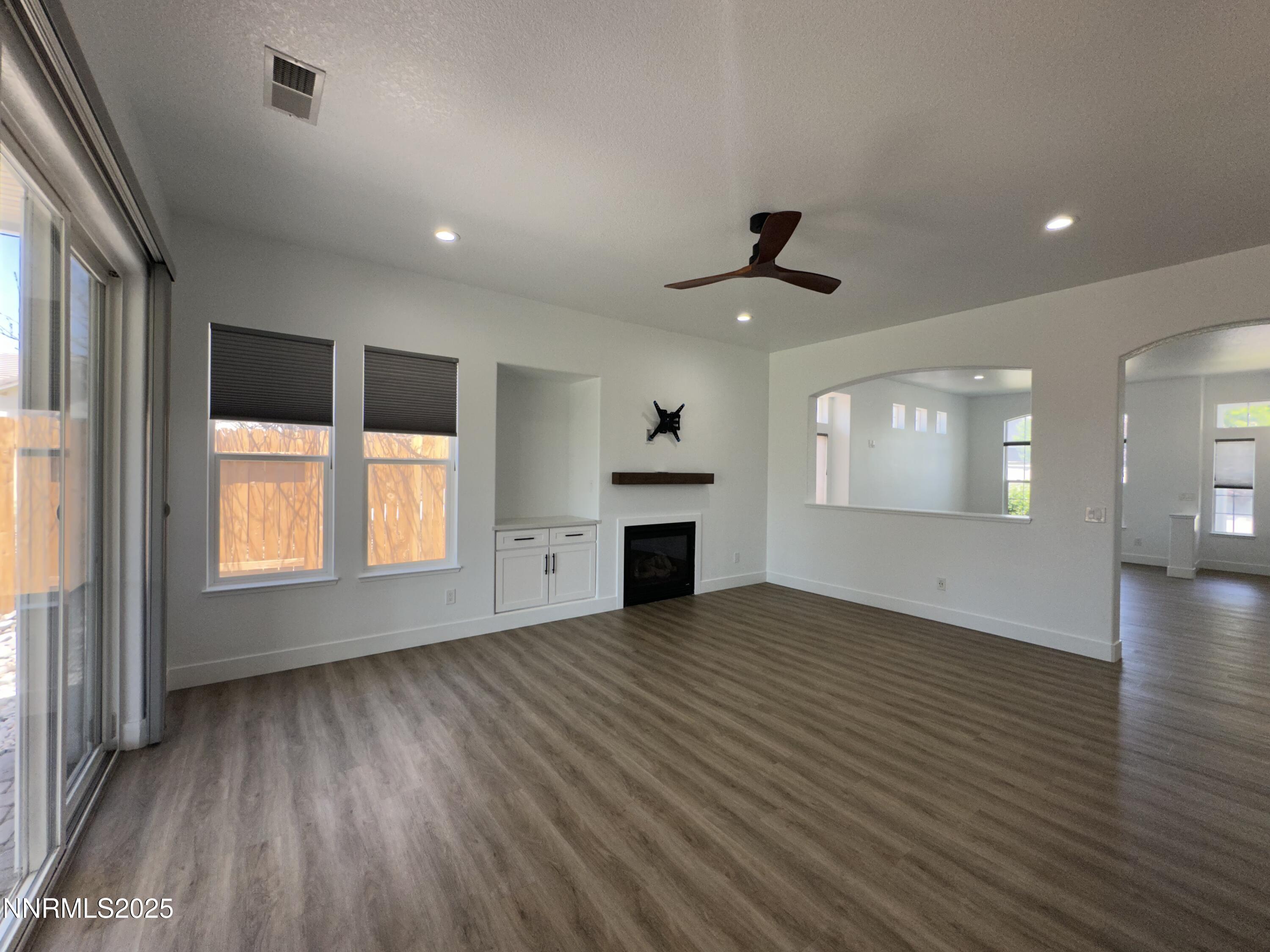 9533 Steep Climb Court Reno, NV 89521 - Photo 12 of 34 an empty room with windows and fireplace
