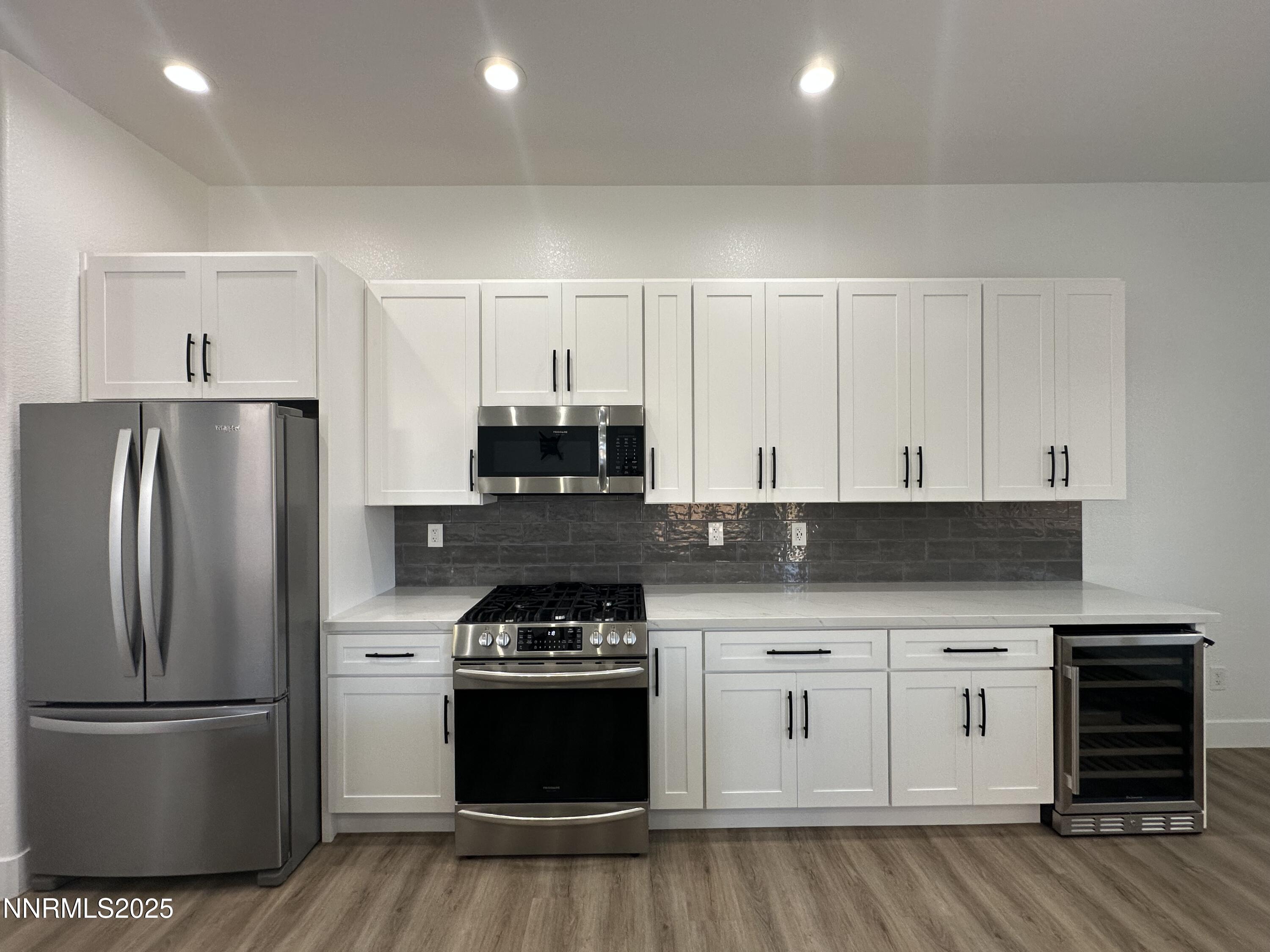 9533 Steep Climb Court Reno, NV 89521 - Photo 15 of 34 a kitchen with stainless steel appliances granite countertop a refrigerator and a stove