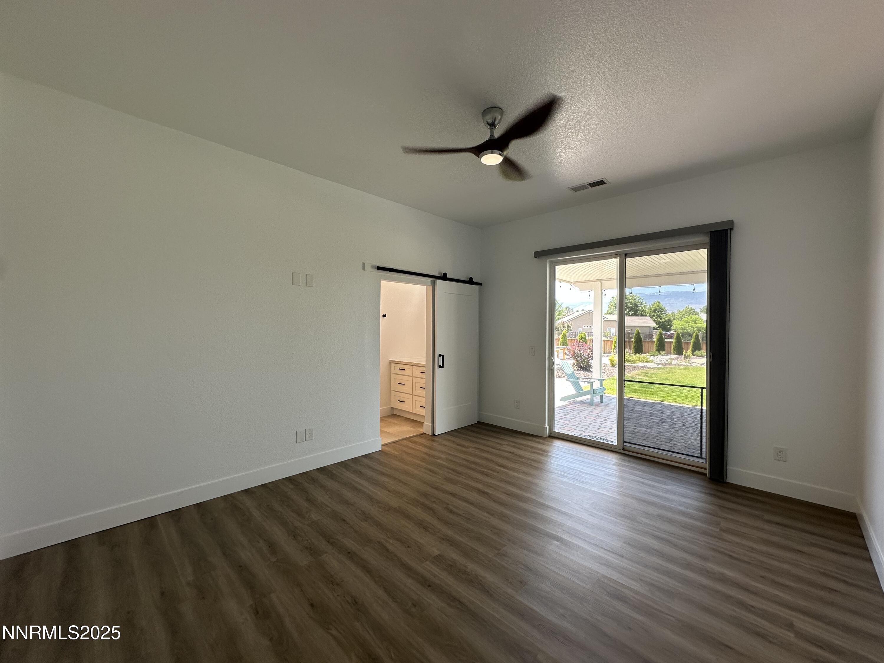 9533 Steep Climb Court Reno, NV 89521 - Photo 17 of 34 an empty room with wooden floor and windows