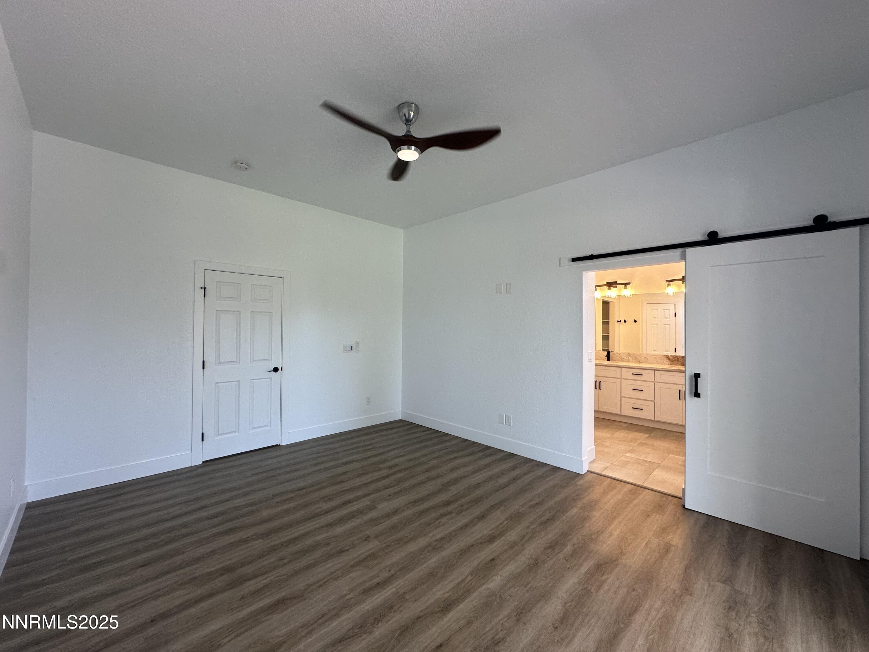 9533 Steep Climb Court Reno, NV 89521 - Photo 18 of 34 an empty room with wooden floor and windows
