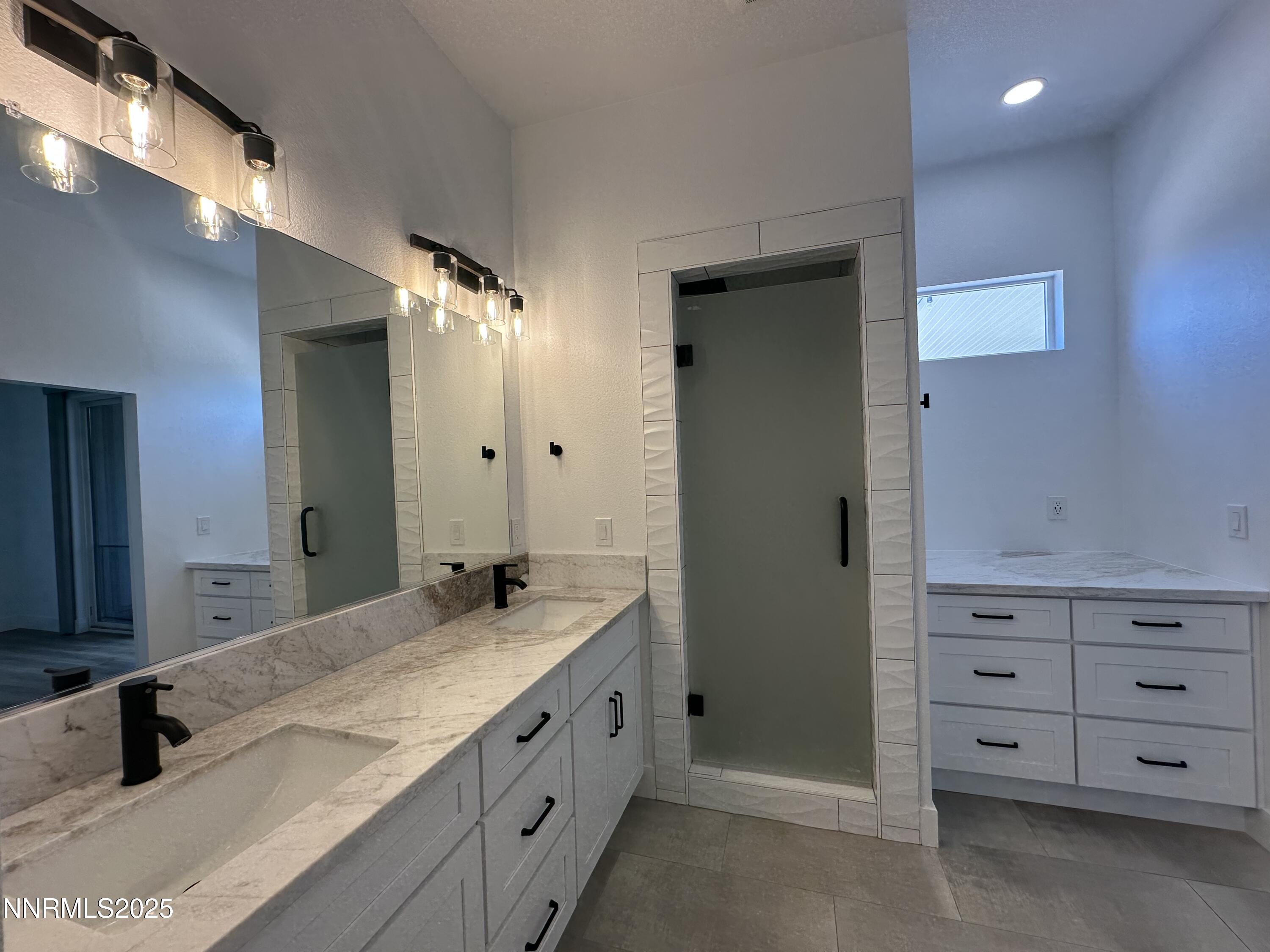 9533 Steep Climb Court Reno, NV 89521 - Photo 19 of 34 a bathroom with double vanity and a mirror