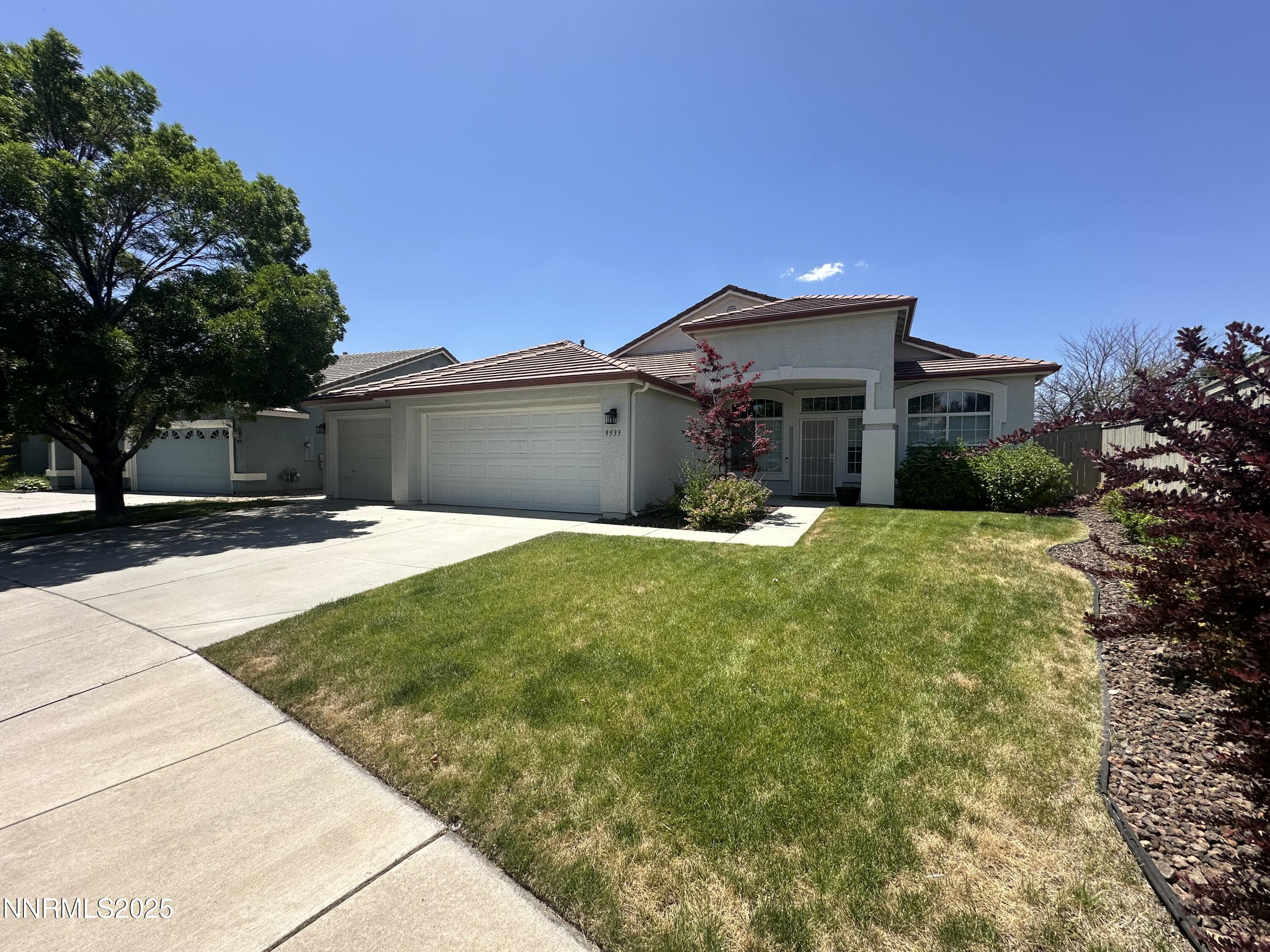 9533 Steep Climb Court Reno, NV 89521 - Photo 2 of 34 a front view of a house with a yard
