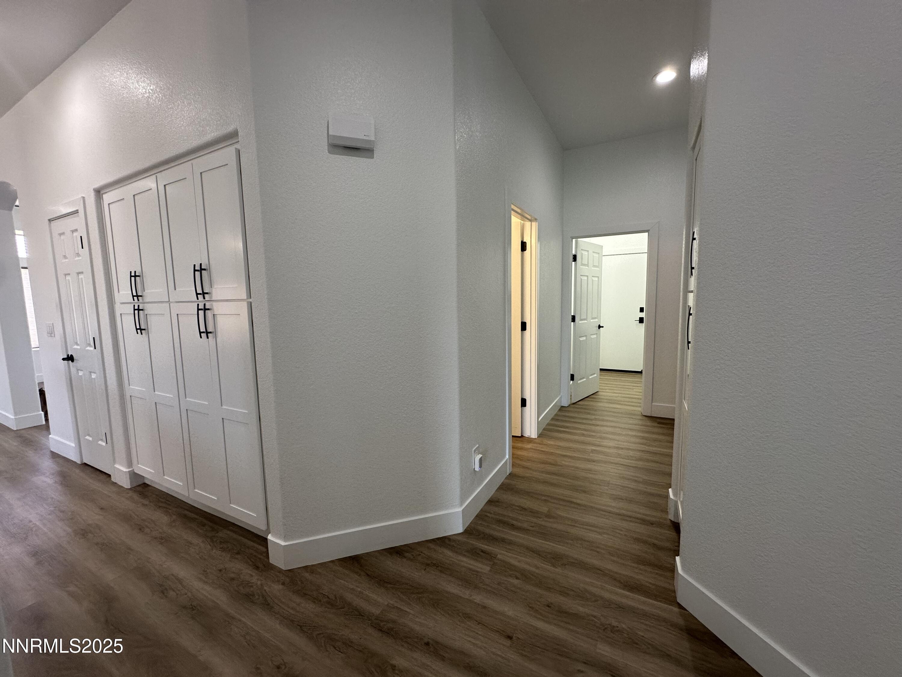 9533 Steep Climb Court Reno, NV 89521 - Photo 21 of 34 a view of a hallway with wooden floor