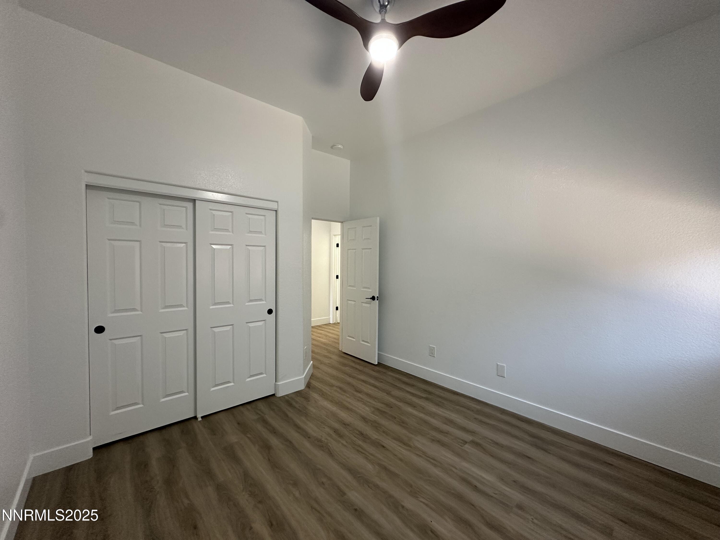 9533 Steep Climb Court Reno, NV 89521 - Photo 22 of 34 a view of an empty room with wooden floor