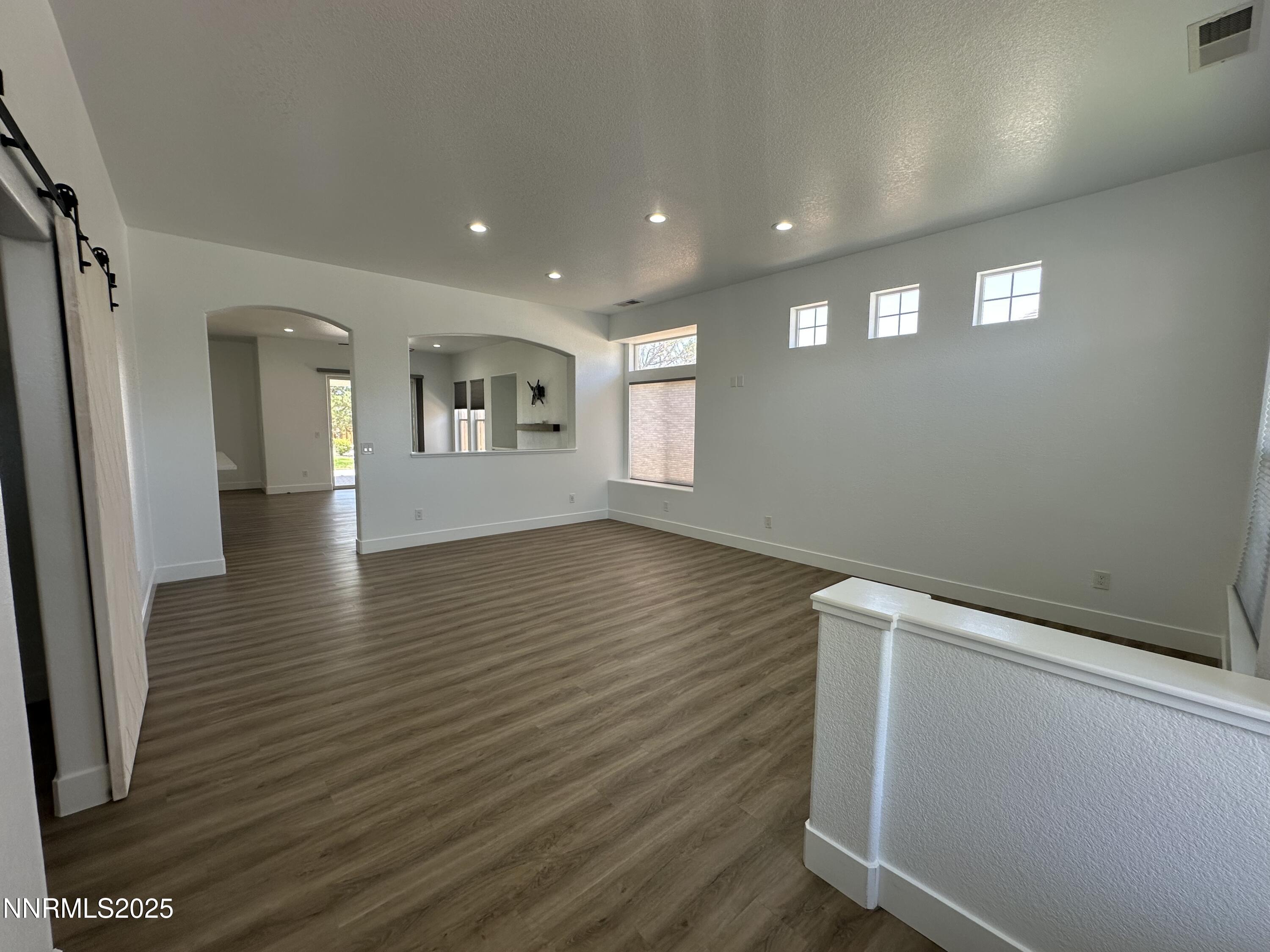 9533 Steep Climb Court Reno, NV 89521 - Photo 3 of 34 a view of empty room with wooden floor and fan
