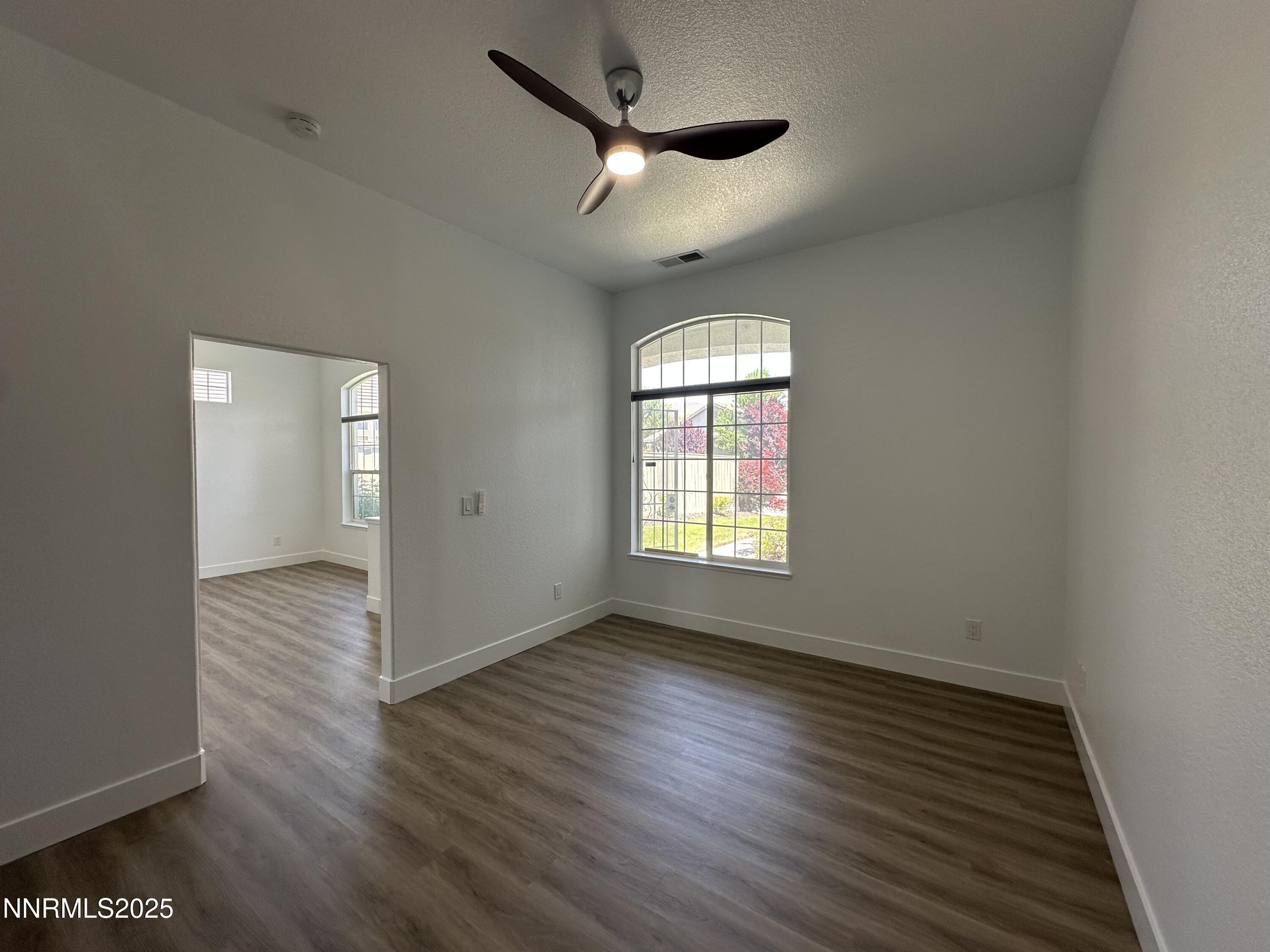 9533 Steep Climb Court Reno, NV 89521 - Photo 8 of 34 wooden floor in an empty room with a window