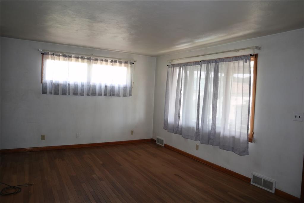 721 Spring Street Roscoe, PA 15477 - Photo 12 of 30 an empty room with wooden floor and windows