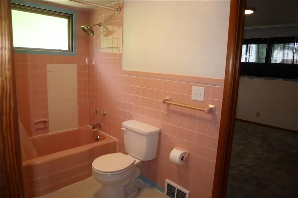 721 Spring Street Roscoe, PA 15477 - Photo 17 of 30 a bathroom with a toilet a sink and bathtub