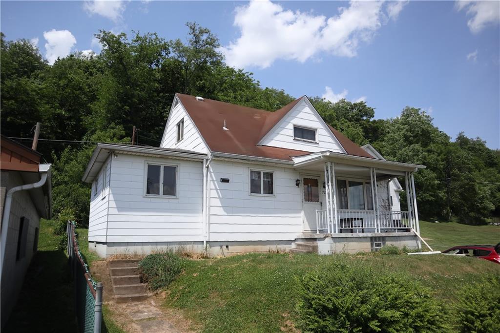 721 Spring Street Roscoe, PA 15477 - Photo 2 of 30 a front view of a house with a yard