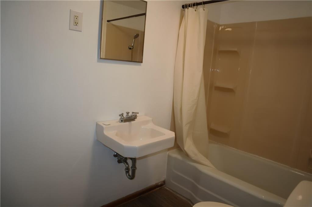 721 Spring Street Roscoe, PA 15477 - Photo 23 of 30 a bathroom with a sink a toilet and shower