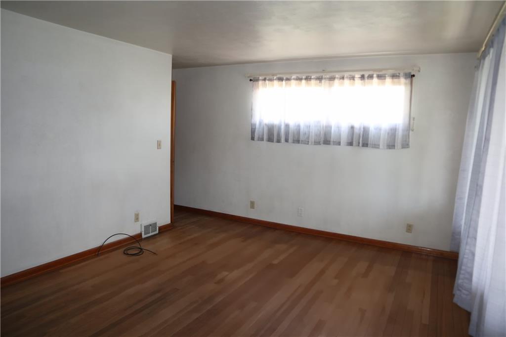 721 Spring Street Roscoe, PA 15477 - Photo 10 of 30 an empty room with wooden floor and windows