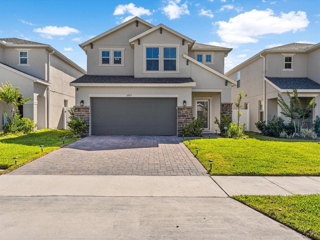 a front view of a house with a yard and garage