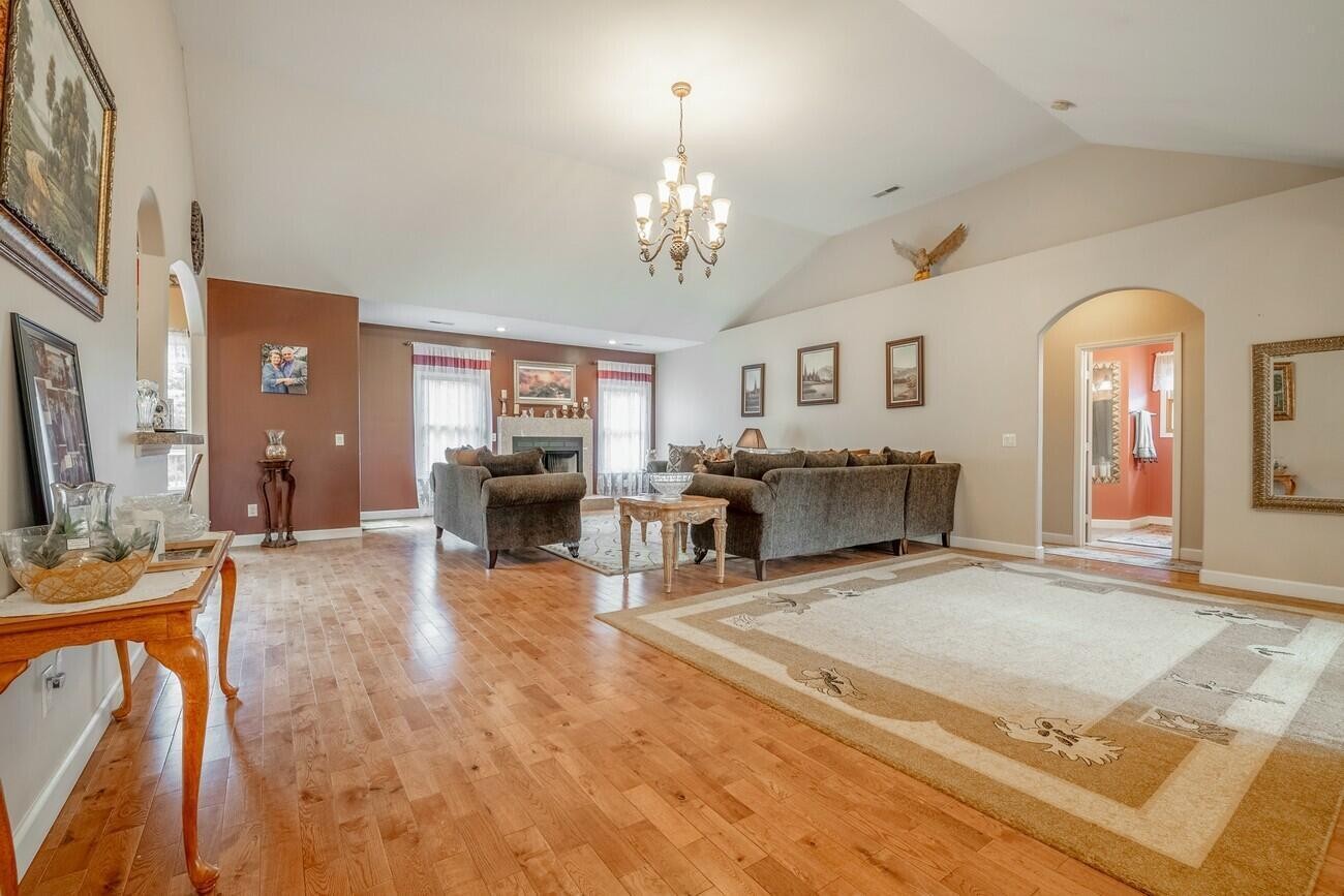 11511 Blair Road Apison, TN 37302 - Photo 21 of 76 a living room with furniture a chandelier and a dining table with wooden floor