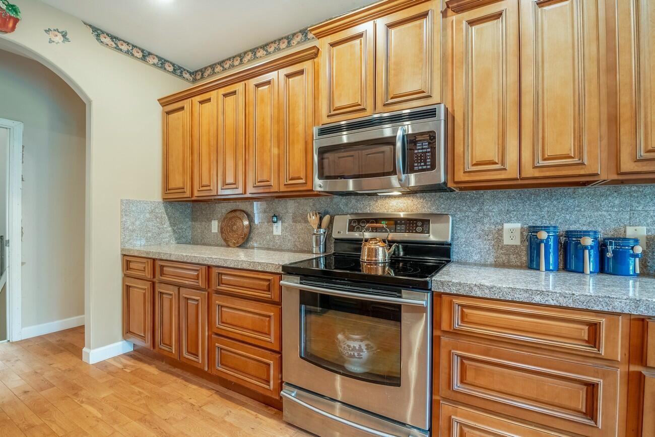 11511 Blair Road Apison, TN 37302 - Photo 28 of 76 a kitchen with stainless steel appliances granite countertop a stove a sink and a microwave