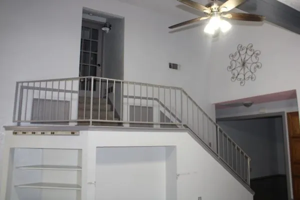 a view of staircase with white walls and a window