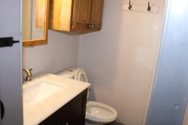 a bathroom with a sink a toilet and a window